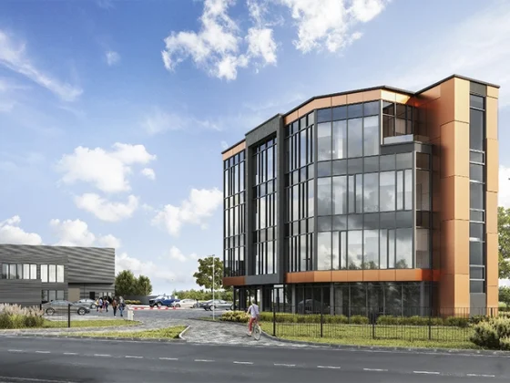 nowoczesny biurowiec z przeszkloną fasadą i miedzianymi panelami – architekt Kraków