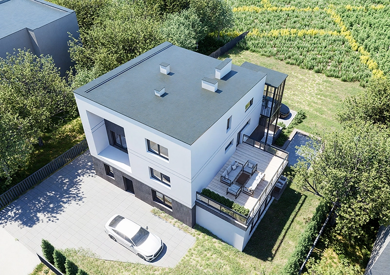 Widok z lotu ptaka na rozbudowaną bryłę domu z tarasem i zagospodarowaną działką.